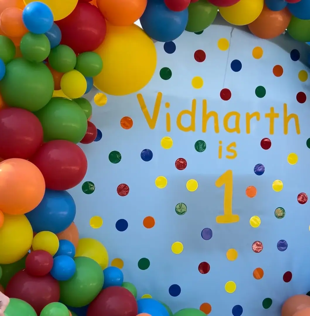 Rainbow balloon garland for a colorful 1st birthday party