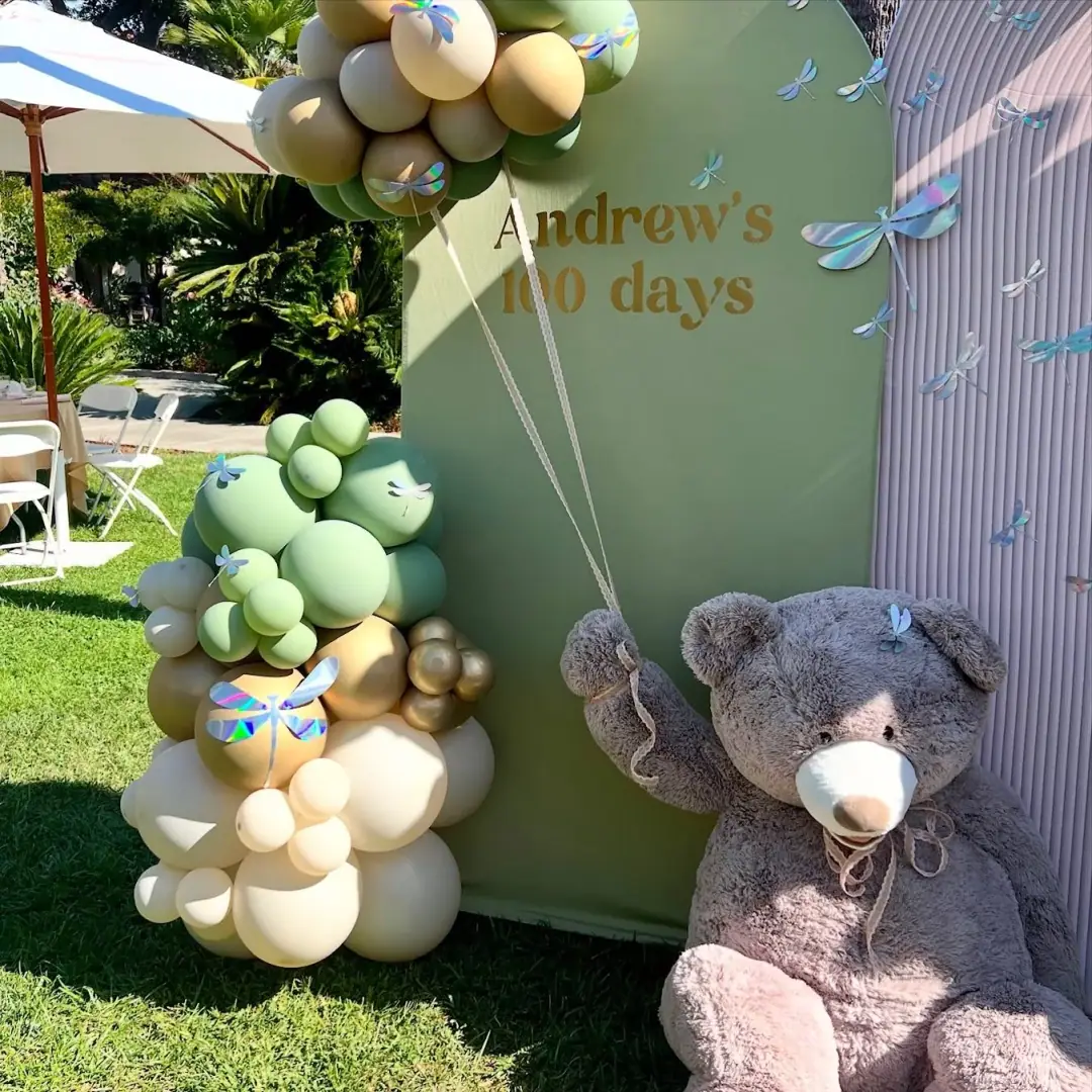 Neutral balloon backdrop with gold accents for a modern celebration