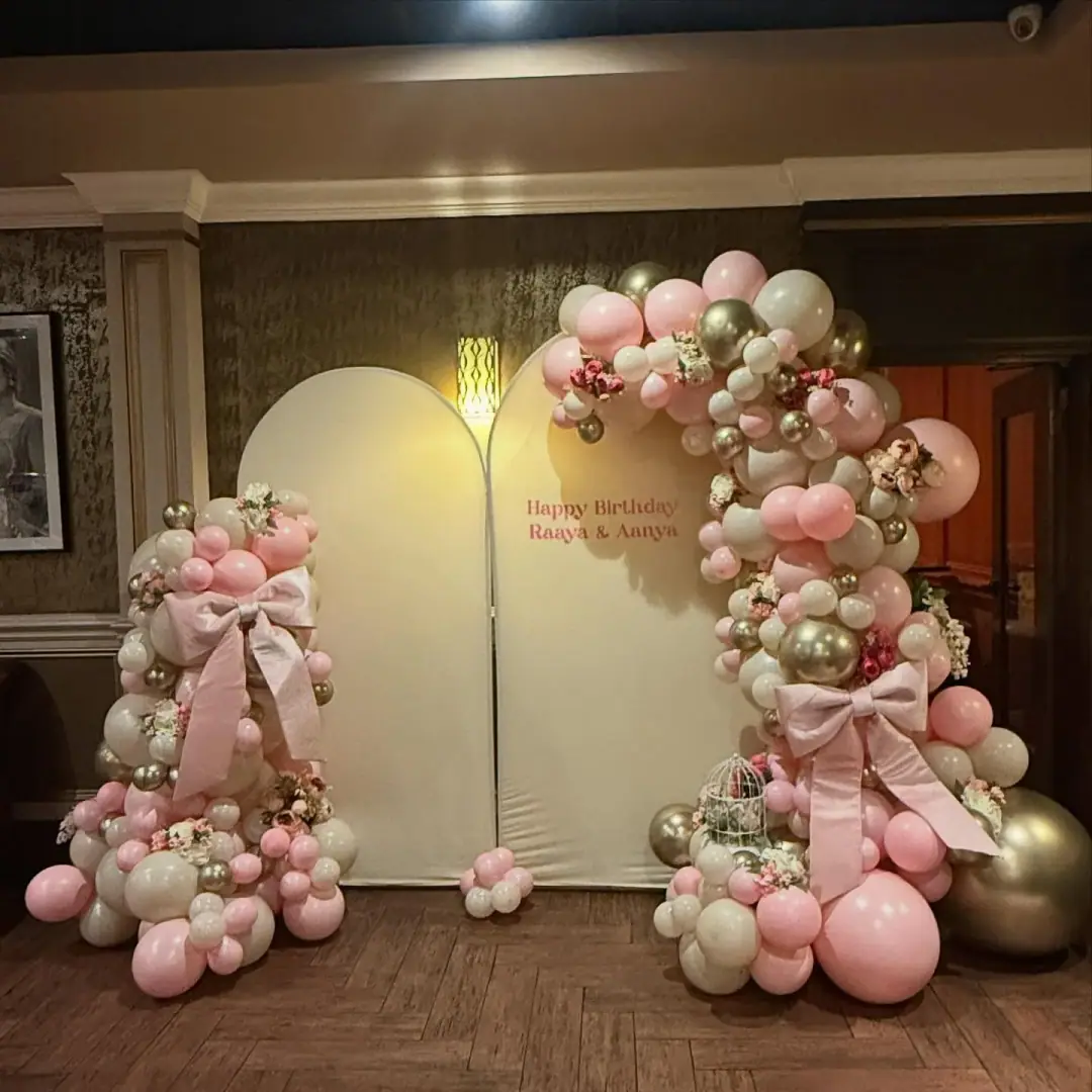 Elegant indoor balloon arch installation in a venue hall