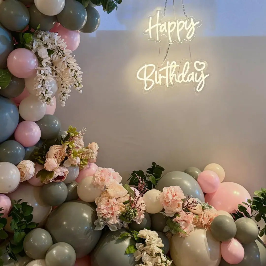 Sage green balloon cluster with floral accents