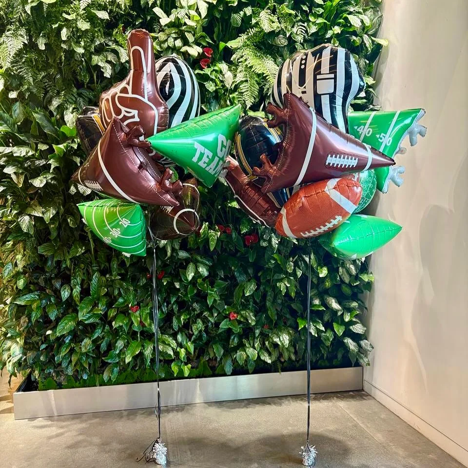 Football-themed helium balloon bouquets arranged in team colours