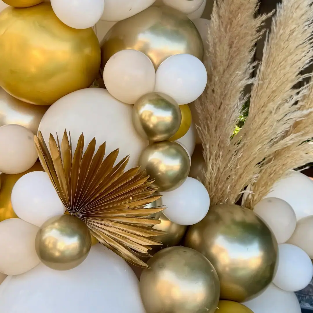 Gold, white, and champagne balloon décor with romantic textures